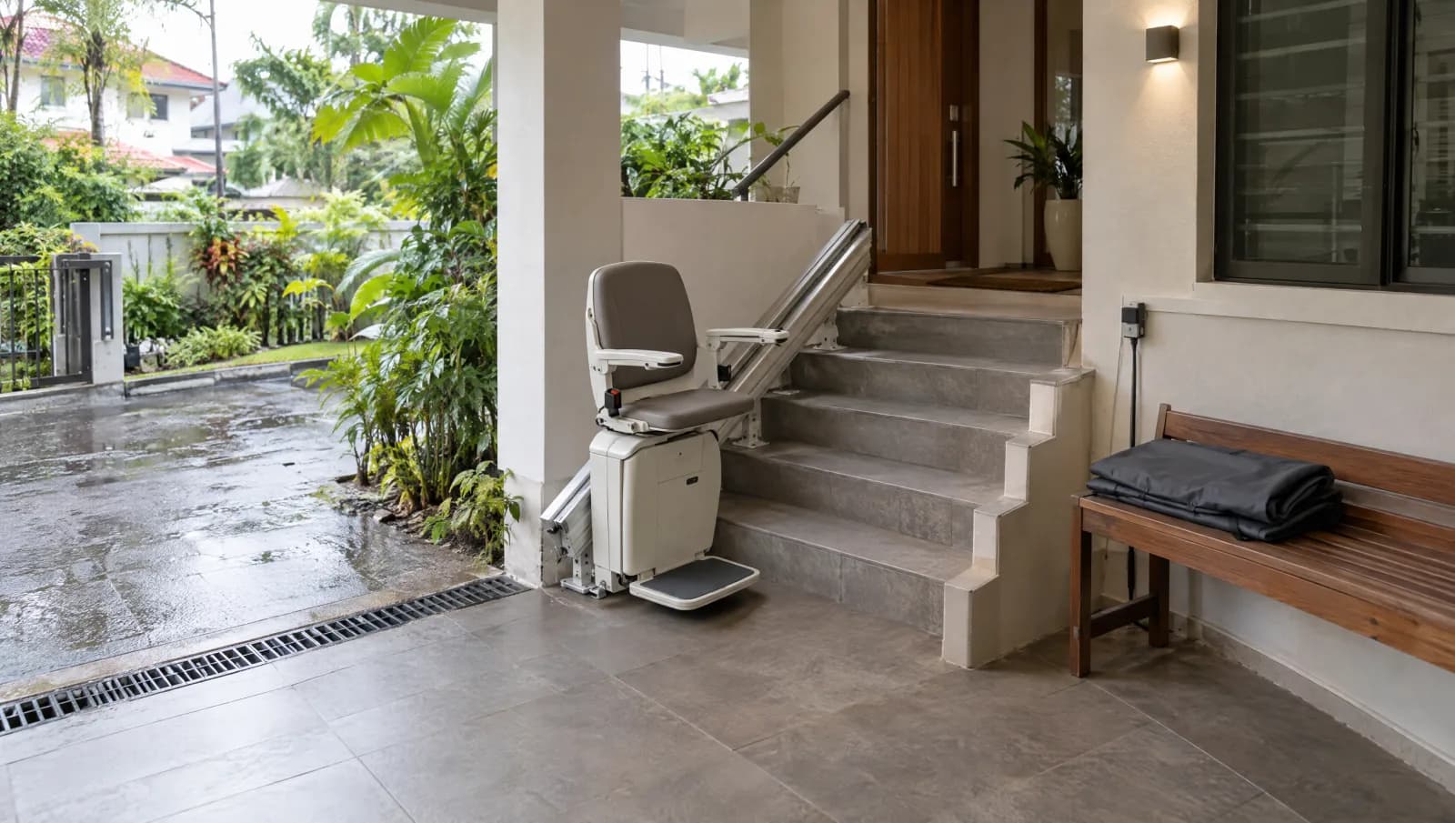 Outdoor stairlift linking a driveway and sheltered porch with clear transfer landings.